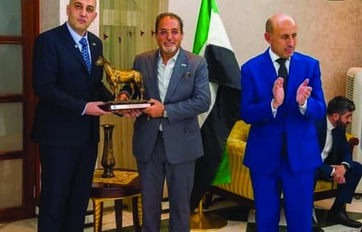 Moafaq A. Al Gaddah receives a commemorative award at an honouring ceremony.