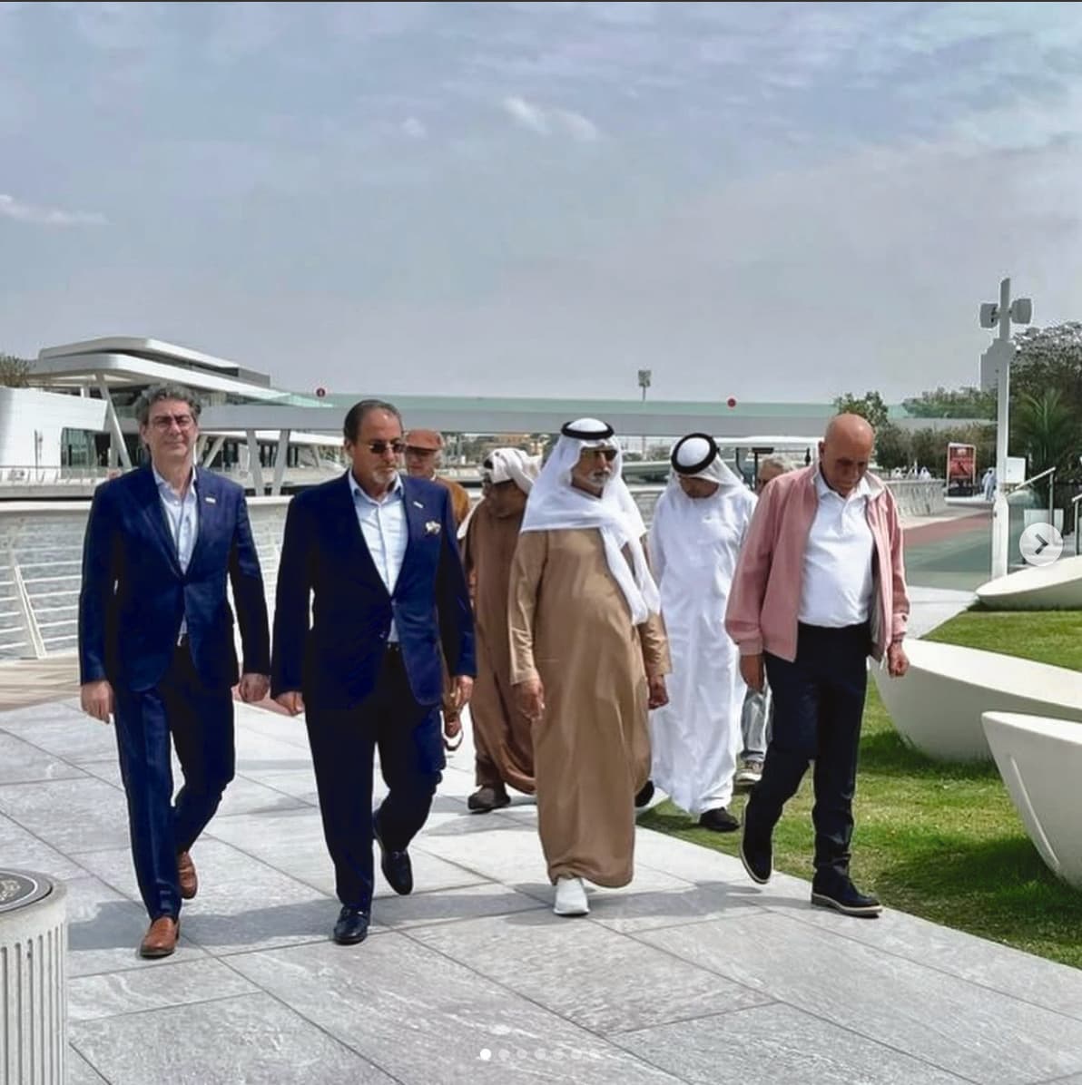 Moafaq A. Al Gaddah walking with colleagues and dignitaries.